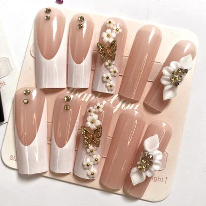 24 nail tips Pink and nude gradient nail art, golden butterflies and white flowers embellish delicate fingertips