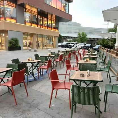 Minimalist modern openwork dining chair, stackable for small apartments, with a backrest.