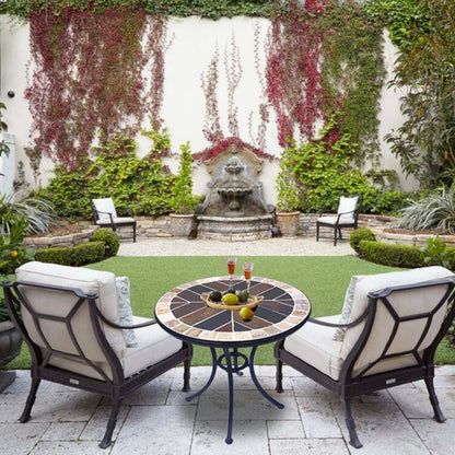 A small round stone table | with a colorful stone - inlaid tabletop and metal legs | an outdoor small round table to start a cozy leisure time.