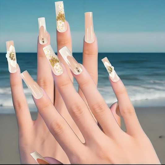 Pink and nude gradient nail art, golden butterflies and white flowers embellish delicate fingertips