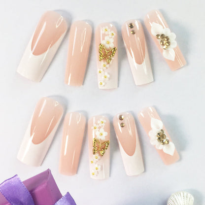 24 nail tips Pink and nude gradient nail art, golden butterflies and white flowers embellish delicate fingertips